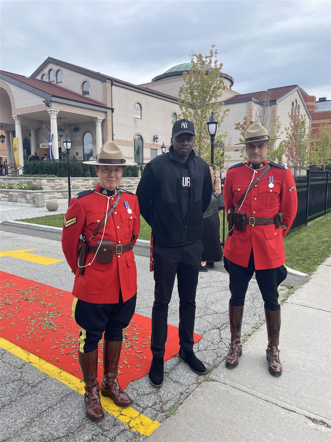 Amani Protection security personnel alongside two RCMP officers in red serge at a Greek Orthodox bishop's installation ceremony in Scarborough, Toronto.